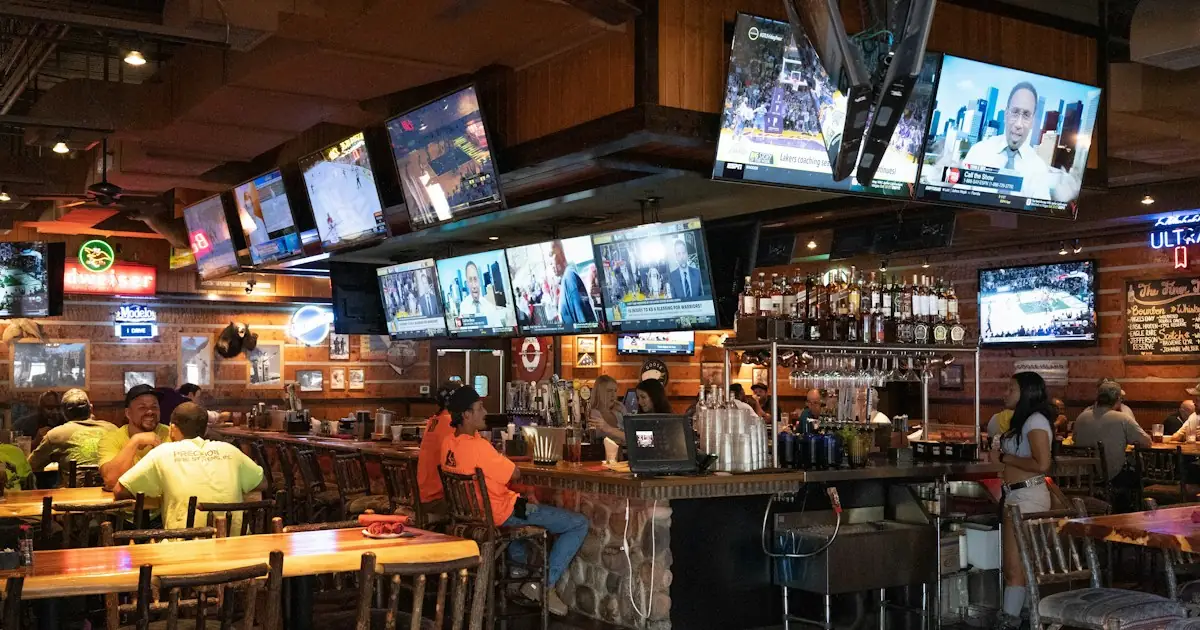 A sports bar with matches showing on many screens