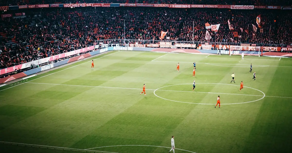 A packed stadium during a daytime football match