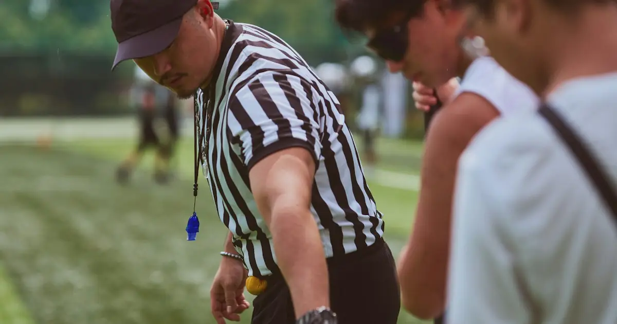 A referee in a striped shirt making a call