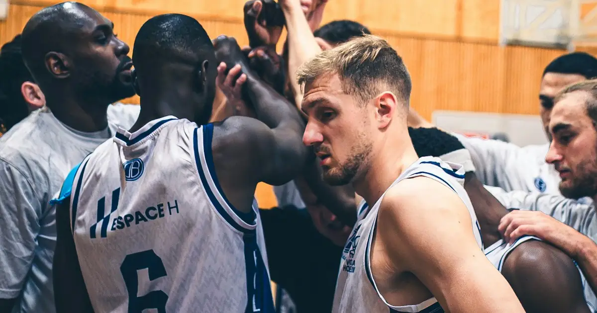 Basketball players huddling with their hands together