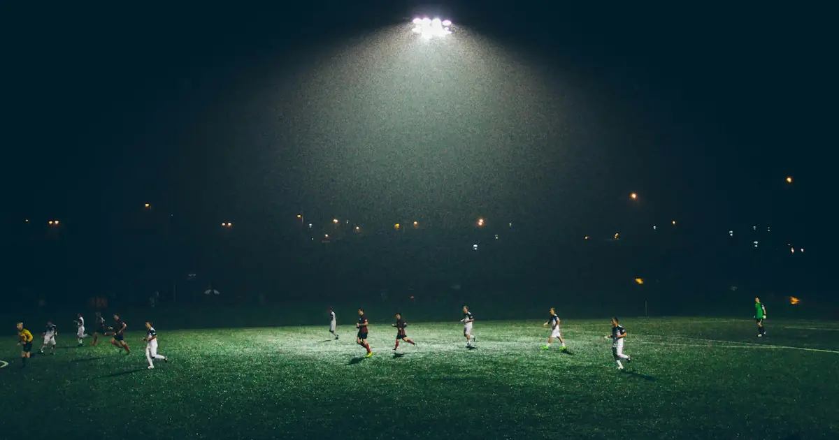 A floodlit football match at night