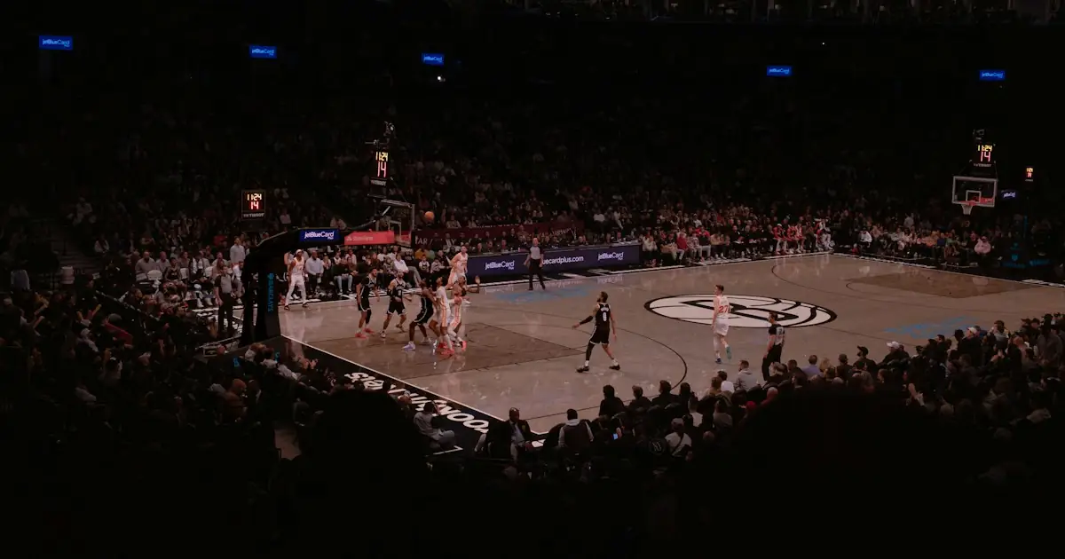 A basketball game in a packed arena under bright lights