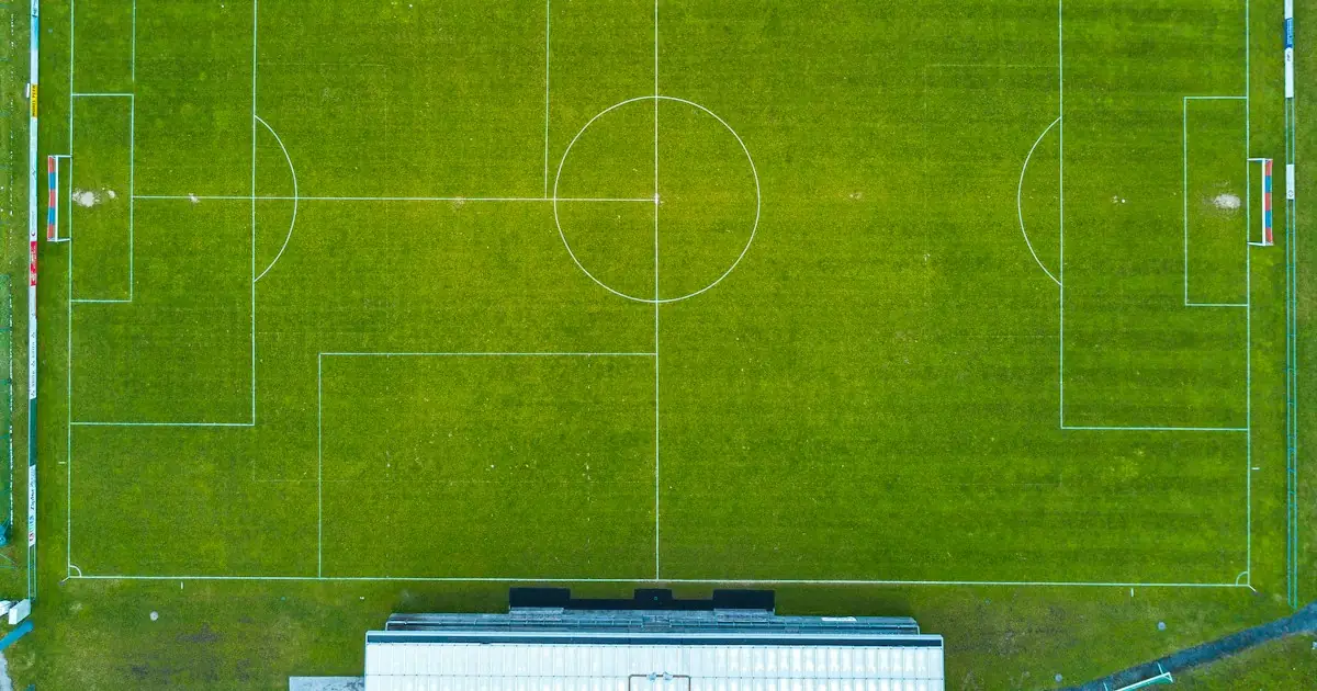 A football pitch from above, from one goal to the other